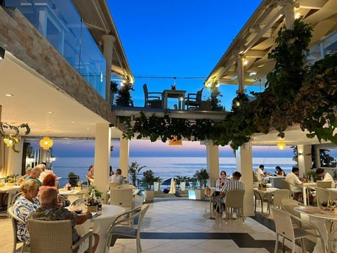 Patio, Restaurant/places to eat, People, Natural landscape, View (from property/room), Balcony/Terrace, Living room, Seating area, Sea view