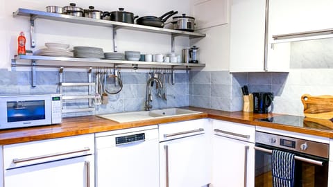 Kitchen or kitchenette, dishwasher, microwave, oven, stove