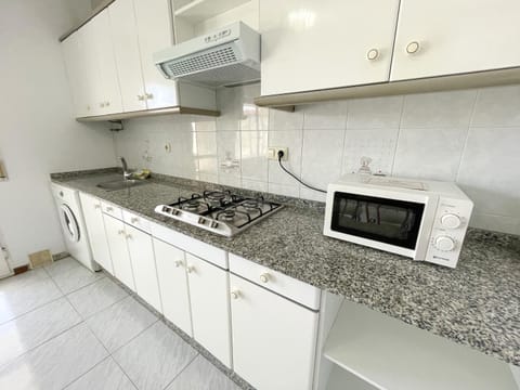 Kitchen or kitchenette, microwave, stove, washing machine