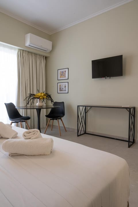 Bed, TV and multimedia, Living room, Seating area, Bedroom, hair dresser, air conditioner