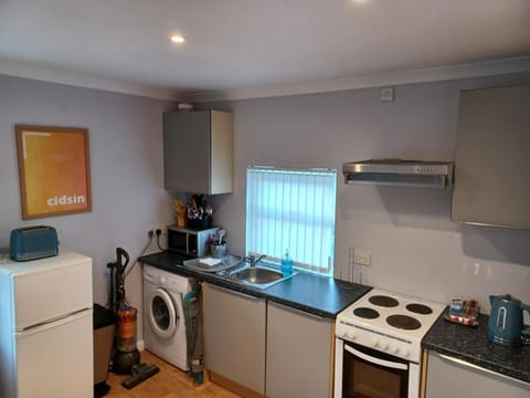 Kitchen or kitchenette, oven, stove, washing machine