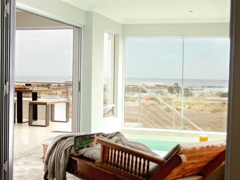 Patio, View (from property/room), Living room, Seating area, Sea view, Swimming pool