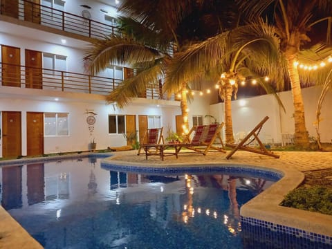 Property building, Patio, Night, Seating area, Pool view, Swimming pool, sunbed