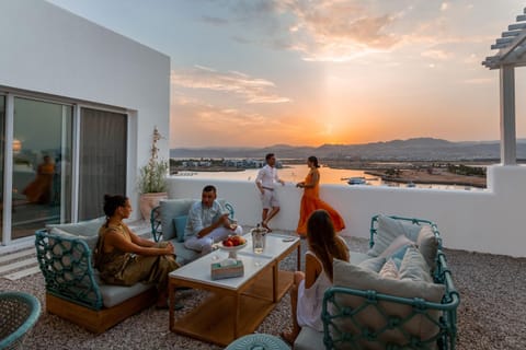 People, View (from property/room), Balcony/Terrace, Food and drinks, Seating area, Guests, Sunset, group of guests