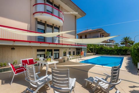 Property building, Patio, Pool view, Swimming pool, sunbed