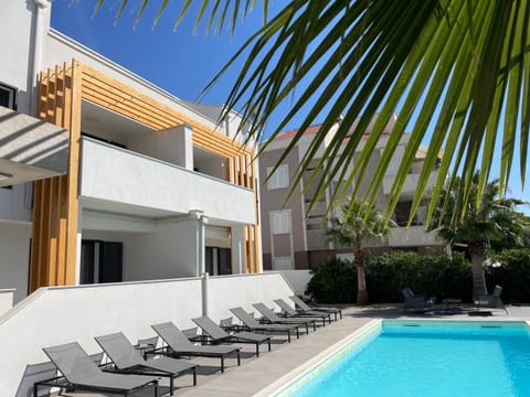 Property building, Patio, Pool view, Swimming pool, sunbed