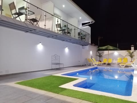 Property building, Patio, Night, Pool view, Swimming pool, sunbed