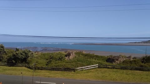 Karoro the beach front bach with views to die for! House in Raglan