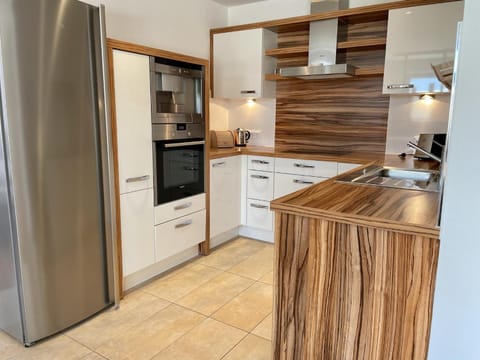 Kitchen or kitchenette, dishwasher, oven, stove