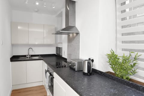 Kitchen or kitchenette, microwave, stove, toaster, washing machine