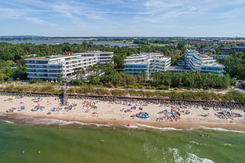 Property building, Nearby landmark, Communal lounge/ TV room, Day, People, Natural landscape, Bird's eye view, Beach, Evening entertainment, City view, Sea view, group of guests, sunbed