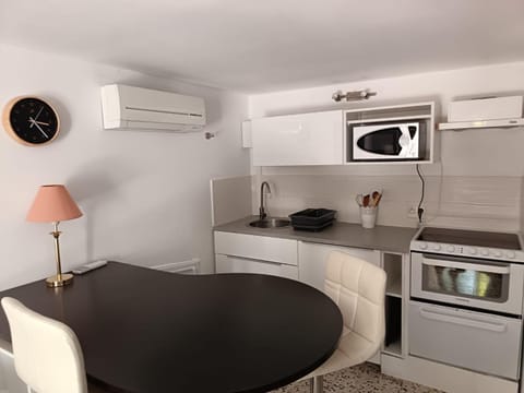 Kitchen or kitchenette, oven, stove, toaster, air conditioner