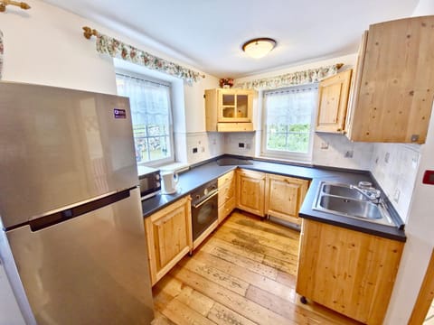 Kitchen or kitchenette, dishwasher, oven, stove