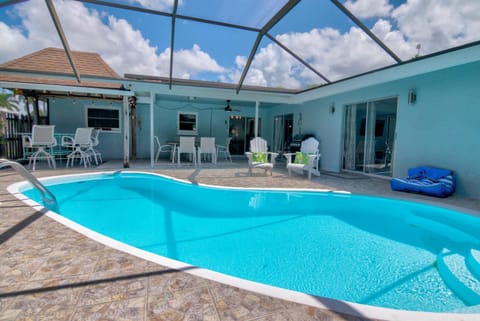 Salt Water Heated Pool Home with a Tiki Bar, a Garage Game Room and 4 Bikes House in North Naples
