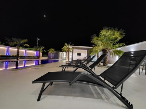 Patio, Night, Pool view, Swimming pool, sunbed