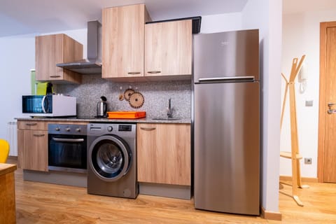 Kitchen or kitchenette, microwave, oven, stove, washing machine