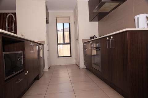 Kitchen or kitchenette, dishwasher, oven, stove