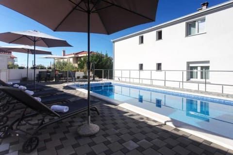 Property building, Patio, Pool view, Swimming pool, sunbed