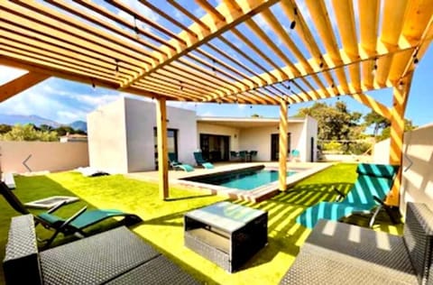 Property building, Patio, Day, Natural landscape, Living room, Seating area, Pool view, Swimming pool, sunbed