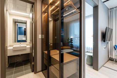 Suite | Bathroom | Shower, hair dryer, slippers, towels