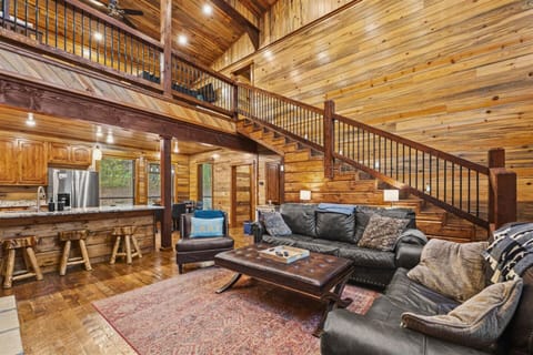 Relax in our expansive living room with high ceilings, a stone fireplace, and stylish comfort.