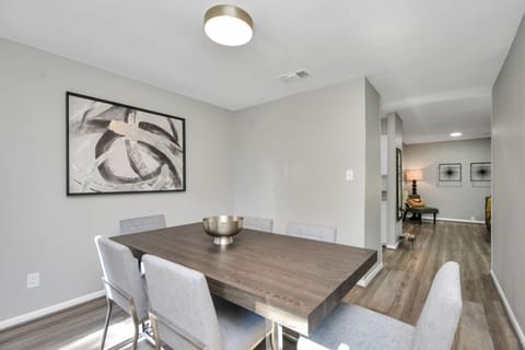 The dining area is conveniently next to the kitchen, perfect for family dinners.