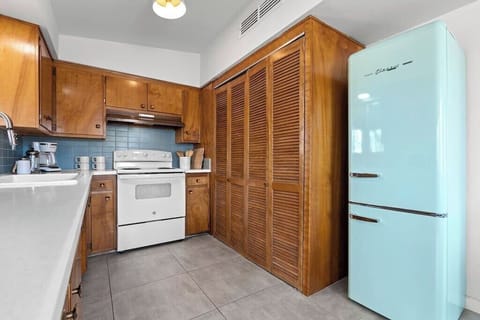The recent kitchen remodel preserved the original wood cabinetry while adding new cabinetry and period appropriate backsplash with a splash of color. And of course, the retro style fridge adds to the nostalgic charm