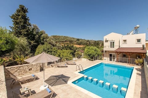 Discover the exterior beauty of the villa, where the private pool awaits, offering a seamless connection between sophistication and relaxation.