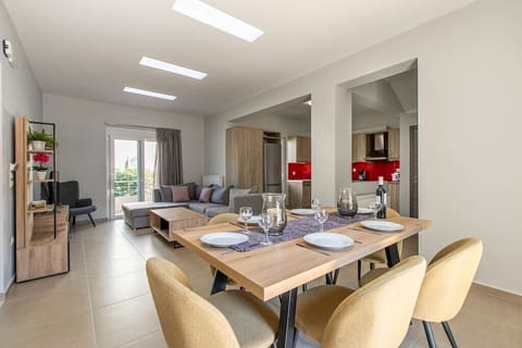 Experience a luminous and welcoming retreat in our living area, where you'll find a comfortable sofa, dining table, well-equipped kitchen, and a balcony for added brightness.