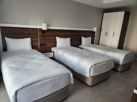 Standard Quadruple Room, Private Bathroom, City View | Premium bedding, minibar, in-room safe, blackout drapes