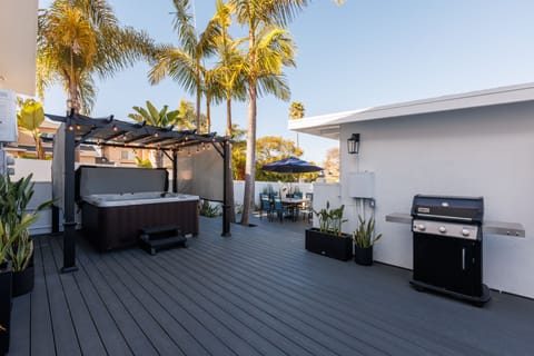 Enjoy the brand new deck, featuring a dining area, seating, a BBQ grill, and private hot tub.