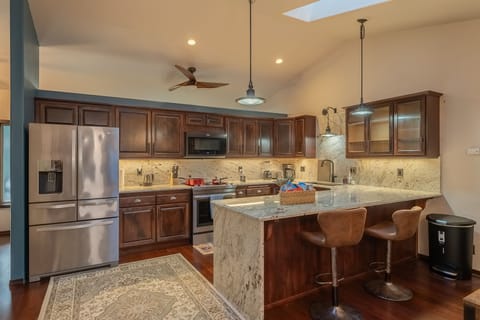 Kitchen with water kettle, blender, coffee maker, microwave and toaster