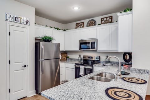 A well-equipped kitchen with modern appliances, ample countertop space, and a built-in heater—perfect for cooking meals in comfort year-round.