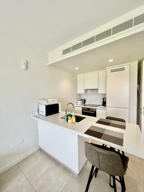 Luxury Suite, 1 Bedroom, Sea View, Poolside | Private kitchen | Full-size fridge, microwave, cookware/dishes/utensils, kitchen islands