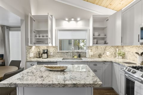 Stocked cabinets with bowls, plates, cups, glasses for your use.