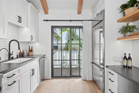 The kitchen is equipped with premium appliances and modern fixtures.