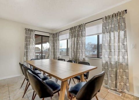 Welcome to our dining room with ample seating, inviting you to gather around and savor your meals in comfort. The well-appointed space ensures a delightful dining experience during your stay at Evergreen Luxe.