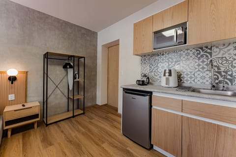 Deluxe Room, 1 Queen Bed | Private kitchen | Fridge, microwave