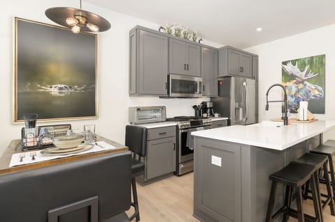 Indulge in gourmet meals at the heart of our home—the fully-equipped kitchen with a functional island.