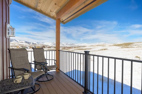 Wake up to breathtaking snowy mountain views from this cozy deck.