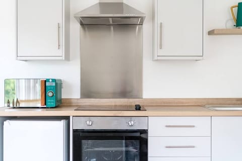 The fully equipped kitchen and adjacent dining area are where you'll get to prepare and enjoy delicious meals with your loved ones before relaxing in the living room, which sets the stage for memorable evenings.