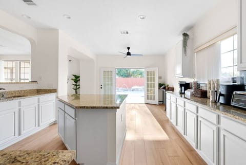 House 1 - Cooking made easy in our kitchen with a sleek center island. Spacious, clean, and ready for your culinary adventures.