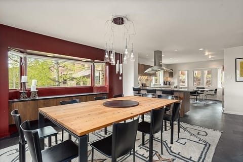 The dining room table offers seating for 10 or a few guests can oversee the preparation of meals while sitting at the kitchen bar.