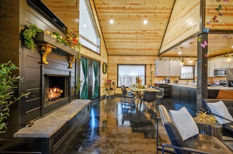 Open concept living room + dining room + kitchen with cozy propane fireplace
