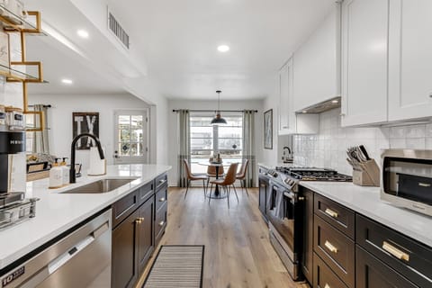 A spacious kitchen with elegant finishes and a cozy dining nook, perfect for both casual breakfasts and dinner parties.
