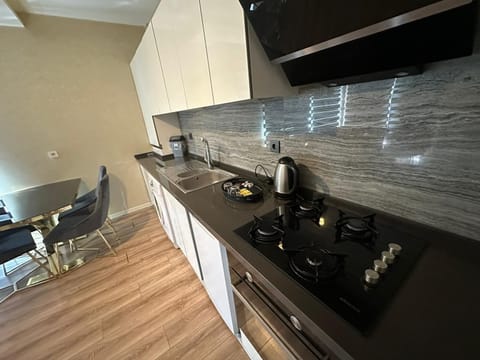 Deluxe Condo | Private kitchen | Mini-fridge, microwave, rice cooker, cleaning supplies