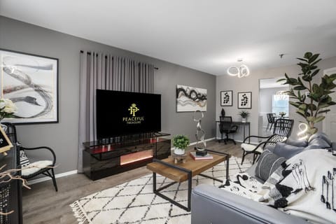 Embrace domestic nirvana with a fluffy carpet underfoot, lively houseplants, and a colossal HDTV for non-stop amusement!