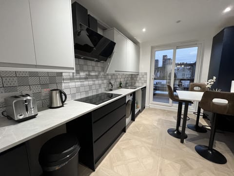 Luxury Studio Suite, City View | Shared kitchen | Full-size fridge, microwave, oven, stovetop