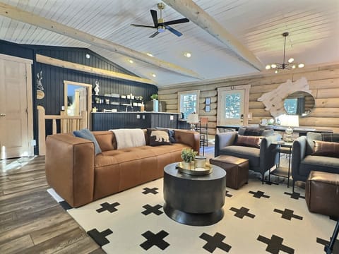 Step into our newly minted 2024 Scandinavian-style abode, where a grand great room with authentic log walls and an inviting open layout awaits.