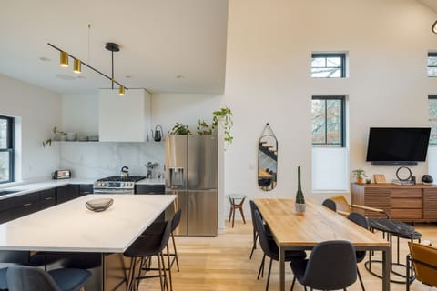 Plenty of seating for all between the dining table and additional barstool seating at the kitchen island.